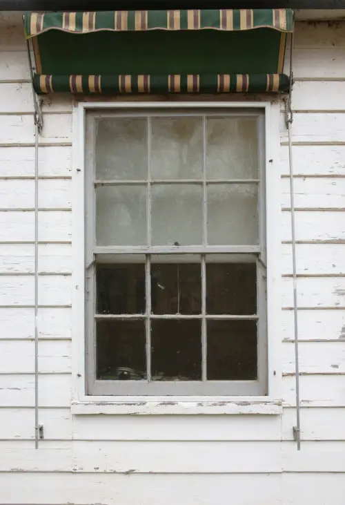 window in a white wooden wall